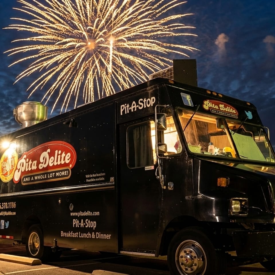 Pita Delite food truck parked at night with bright fireworks exploding in the dark sky.
